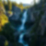Majestic waterfall cascading down rocky cliffs surrounded by lush greenery